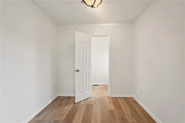 a view of a room with wooden floor