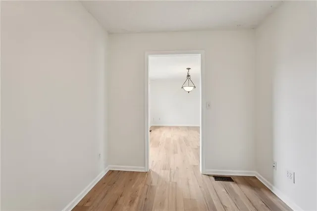 a view of a room with wooden floor