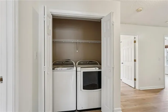 a view of a storage and utility room with washer and dryer