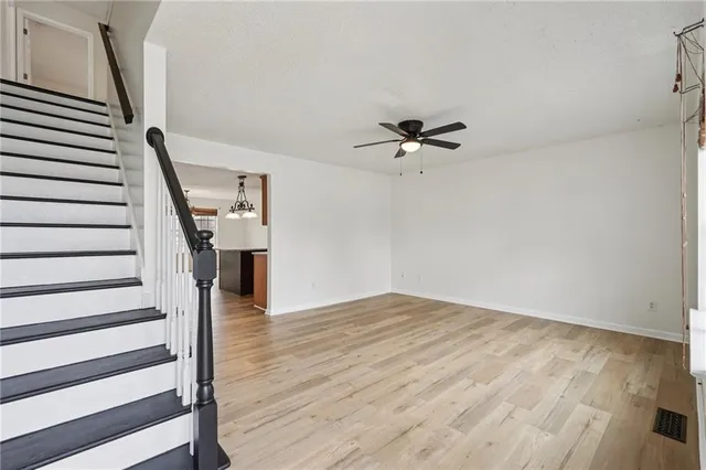 a view of a room with wooden floor and stairs