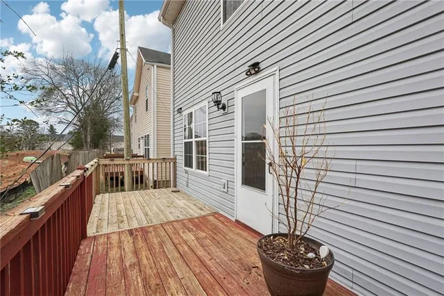 a view of balcony with wooden floor and outdoor seating