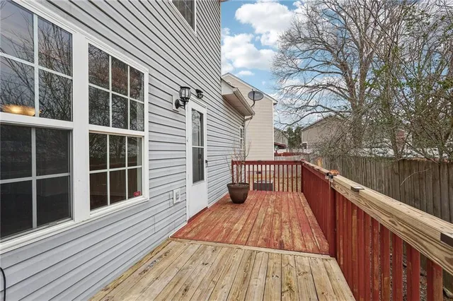 a view of balcony with wooden floor and fence