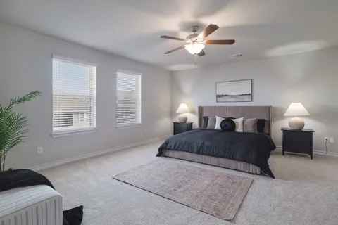 a bedroom with a bed and a chandelier