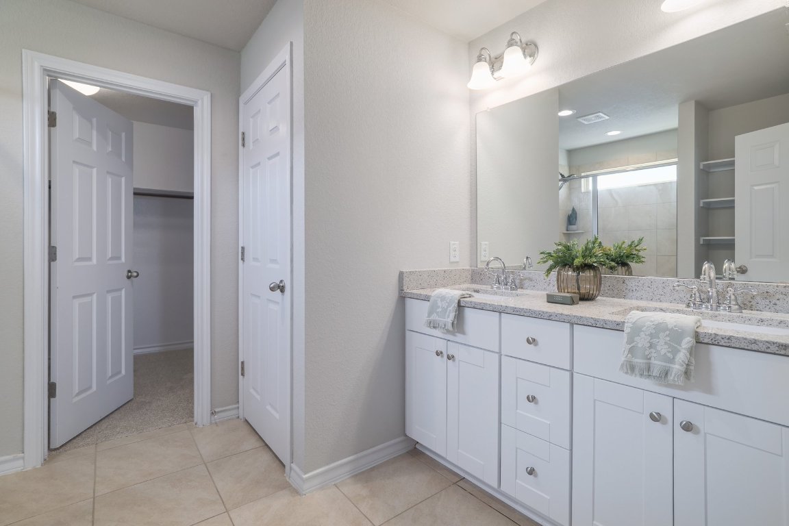 6792 Catania Loop Round Rock, TX 78665 - Photo 18 of 31 a spacious bathroom with double sink and a mirror