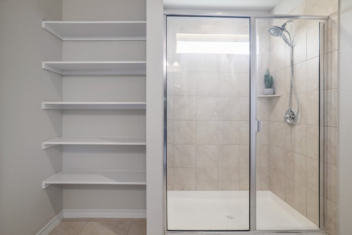 6792 Catania Loop Round Rock, TX 78665 - Photo 19 of 31 a bathroom with a glass shower door