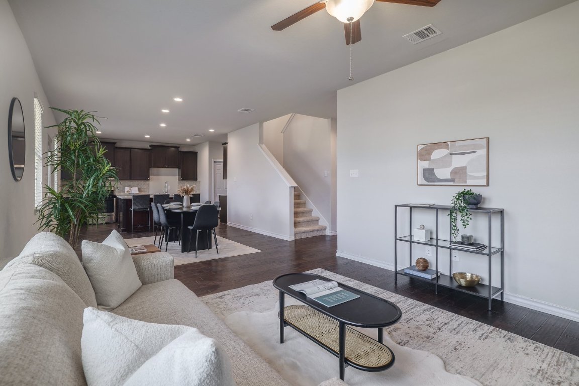 6792 Catania Loop Round Rock, TX 78665 - Photo 3 of 31 a living room with furniture a rug and a chandelier