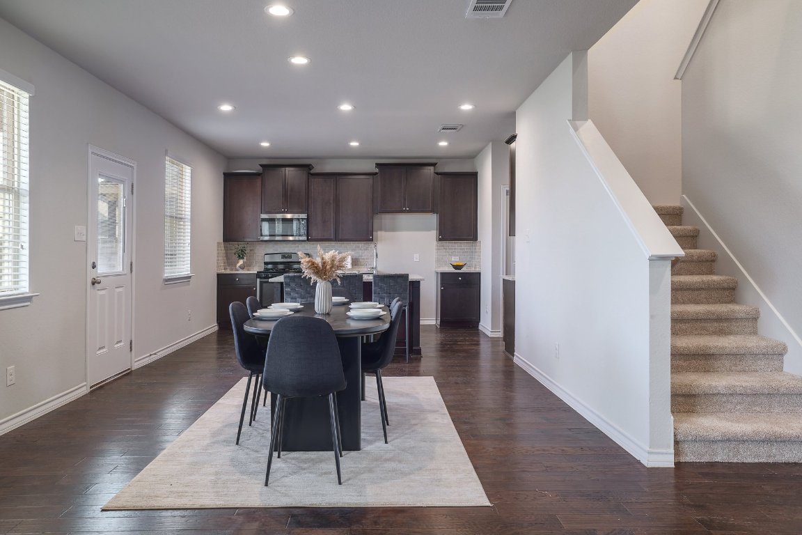 6792 Catania Loop Round Rock, TX 78665 - Photo 5 of 31 a view of a dining room with furniture and wooden floor