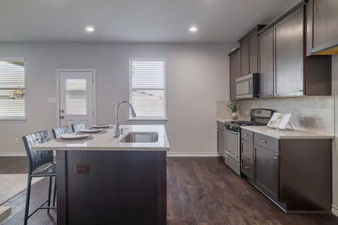 a kitchen with a sink and a refrigerator