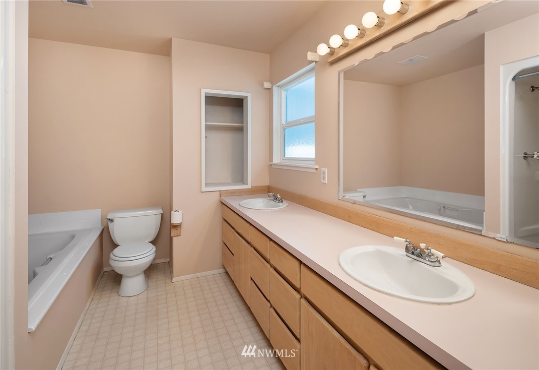 19115 Southeast 128th Street Renton, WA 98059 - Photo 18 of 21 a bathroom with a sink a toilet and a mirror