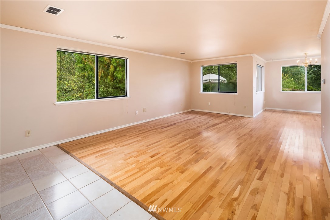 19115 Southeast 128th Street Renton, WA 98059 - Photo 6 of 21 an empty room with wooden floor and windows