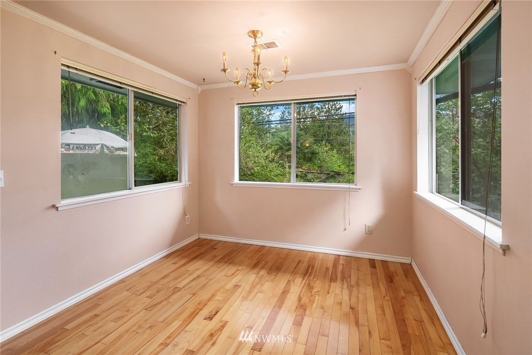 19115 Southeast 128th Street Renton, WA 98059 - Photo 9 of 21 a view of an empty room with wooden floor and a window