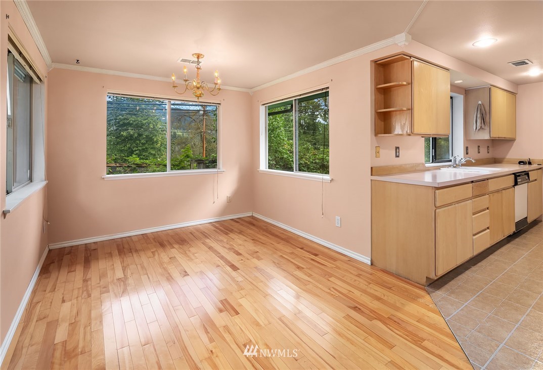 19115 Southeast 128th Street Renton, WA 98059 - Photo 10 of 21 a view of a kitchen and an entryway with wooden floor