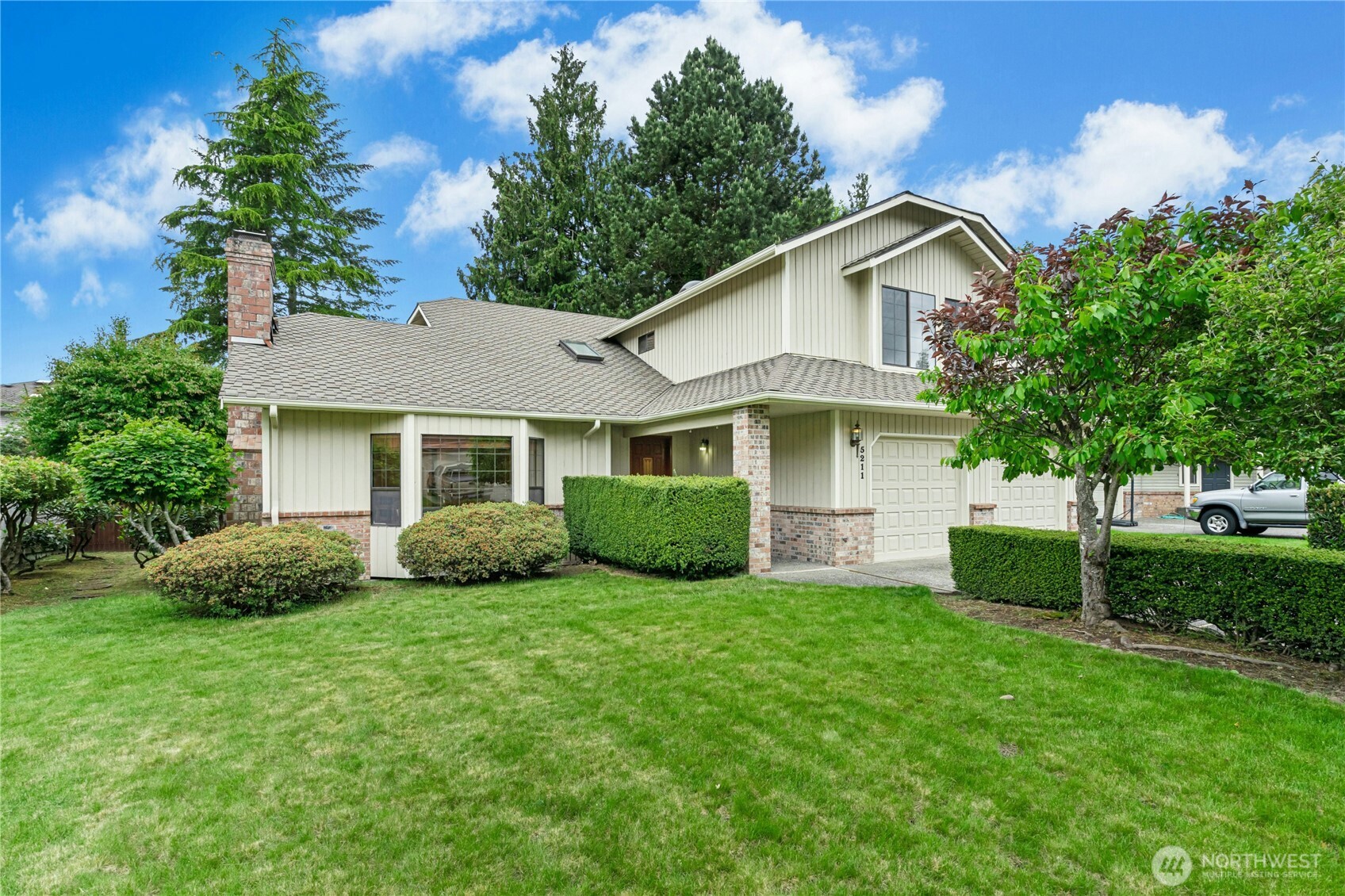 5211 103rd Street Southwest, Unit SW Mukilteo, WA 98275 - Photo 2 of 40 a view of a house with a yard and potted plants