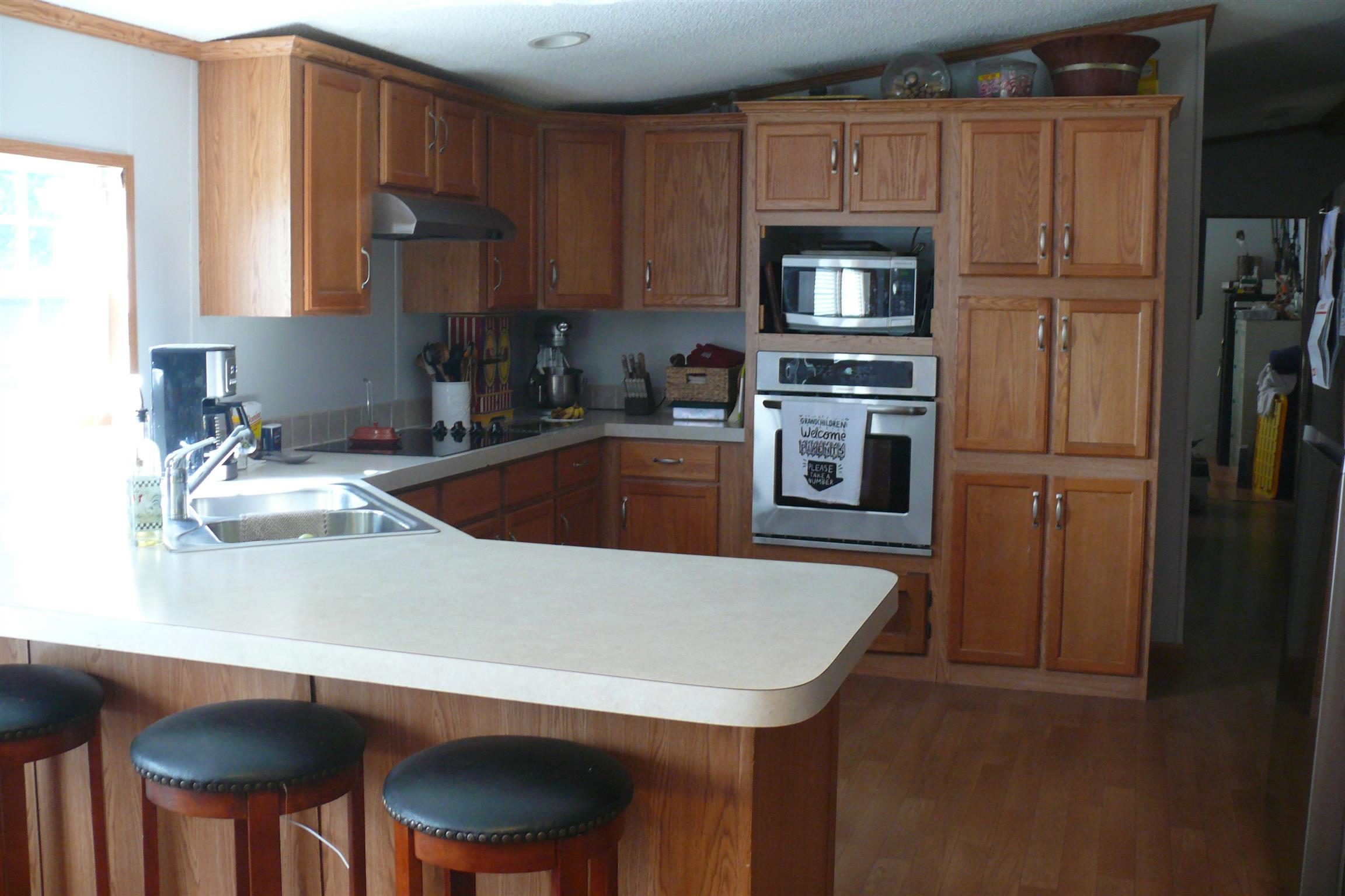 400 Jesse Work Road Dickson, TN 37055 - Photo 3 of 9 a kitchen with stainless steel appliances a sink a microwave a refrigerator and wooden cabinets