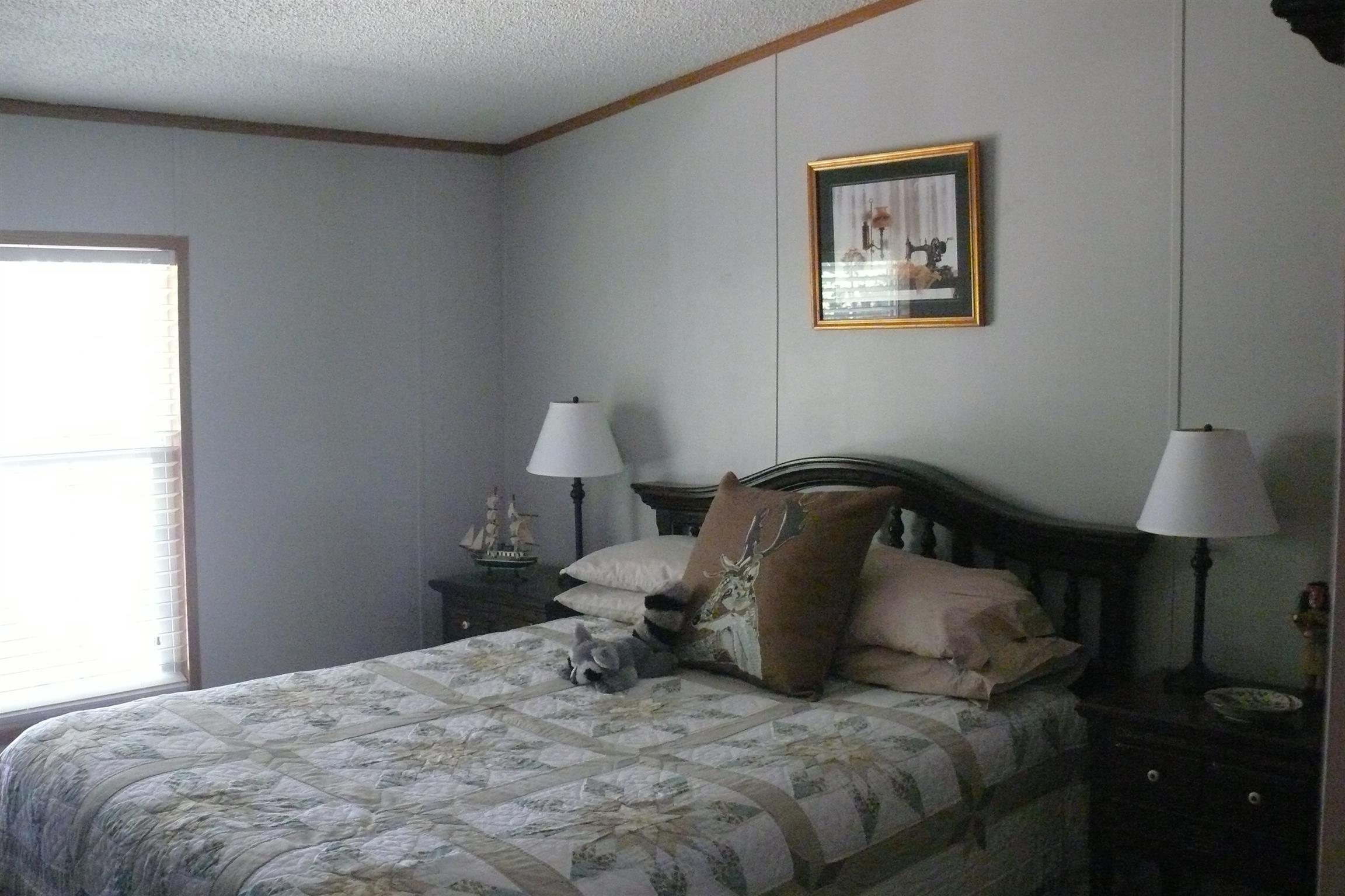 400 Jesse Work Road Dickson, TN 37055 - Photo 5 of 9 a bedroom with a bed and a lamp on the dresser