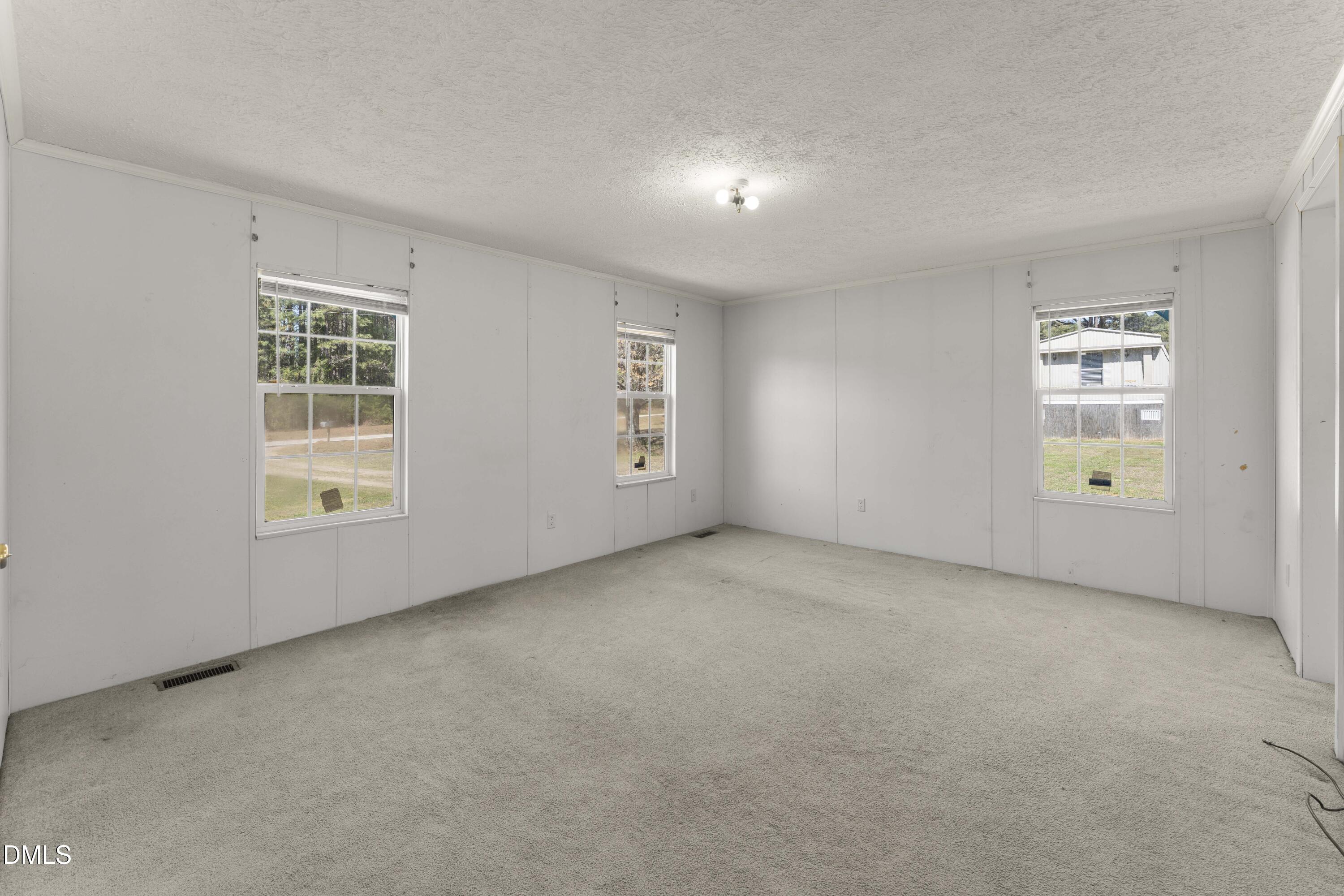 501 Macon-Embro Road Macon, NC 27551 - Photo 11 of 37 an empty room with windows