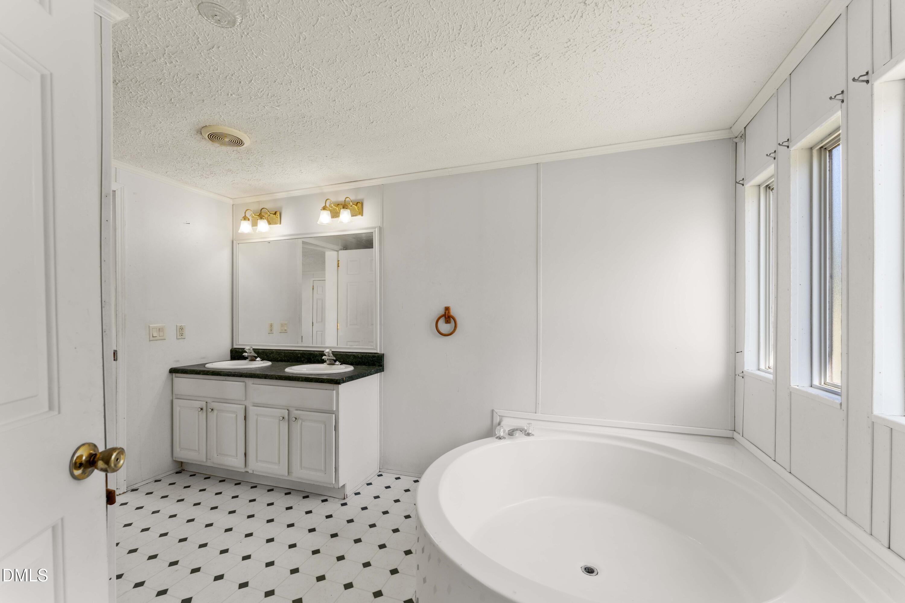 501 Macon-Embro Road Macon, NC 27551 - Photo 14 of 37 a bathroom with a sink a mirror and a bathtub