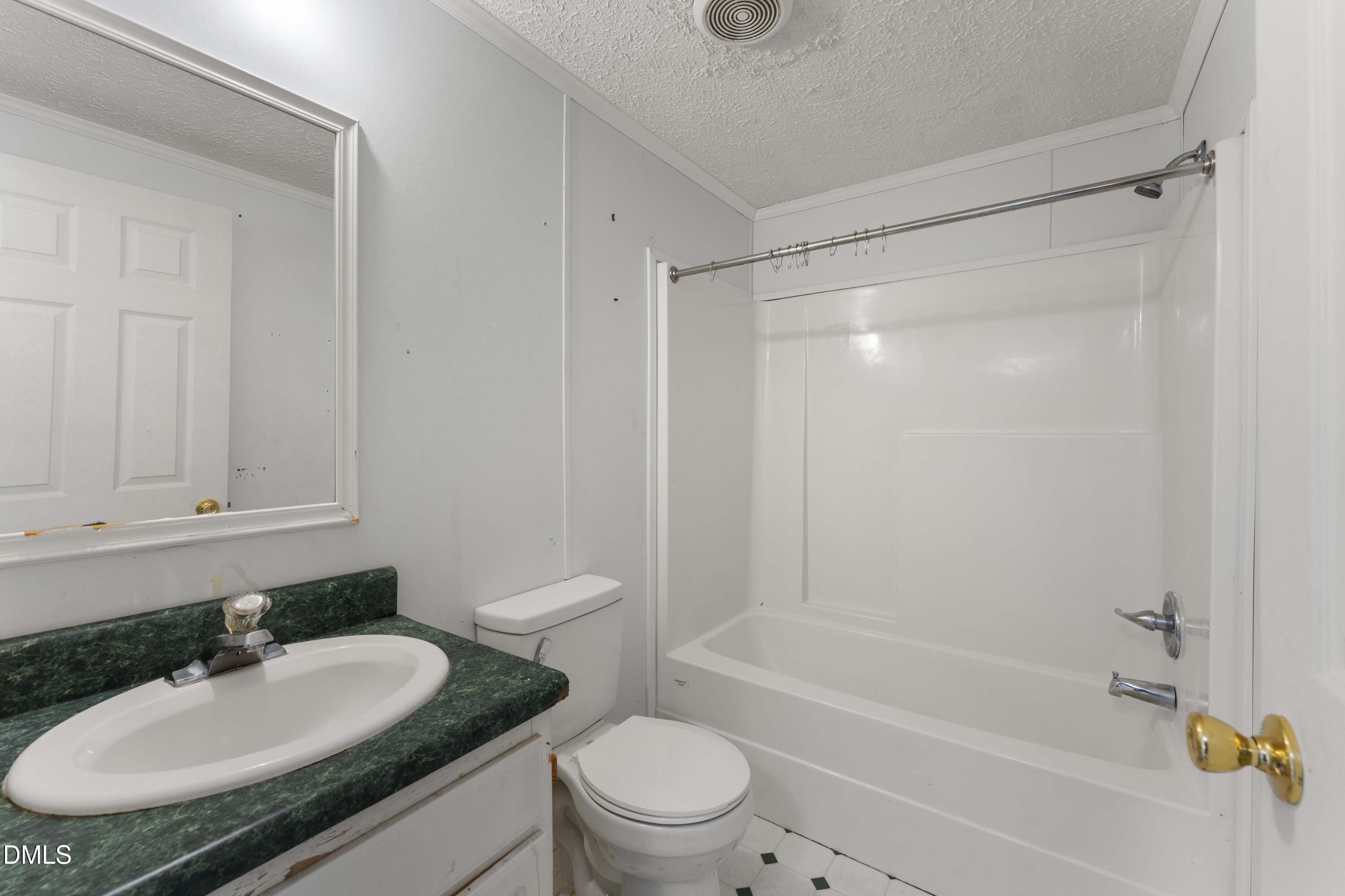 501 Macon-Embro Road Macon, NC 27551 - Photo 20 of 37 a bathroom with a granite countertop sink toilet and shower