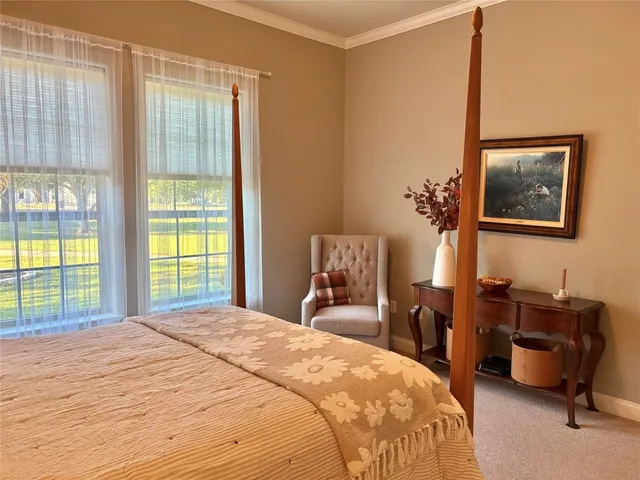 a bedroom with a large bed and a window