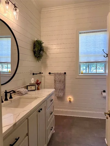 a large bed sitting in a bedroom next to a window