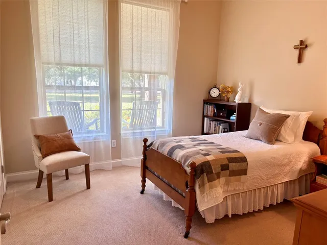 a bedroom with a bed and a mirror on dresser