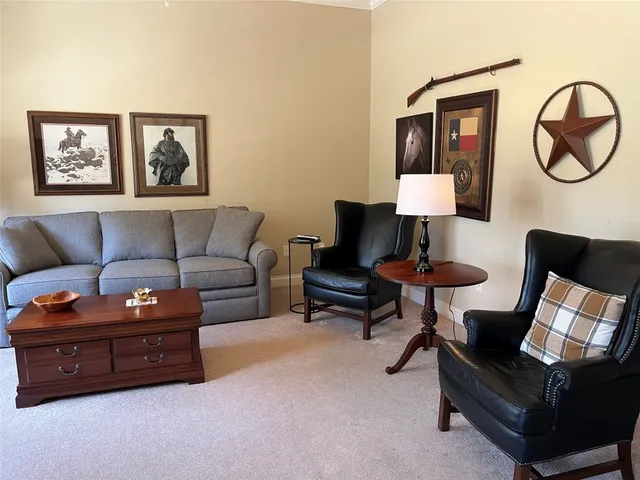a living room with furniture and a lamp