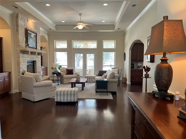 a living room with furniture fireplace and a large window