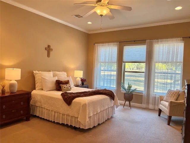 a spacious bedroom with a bed and a couch