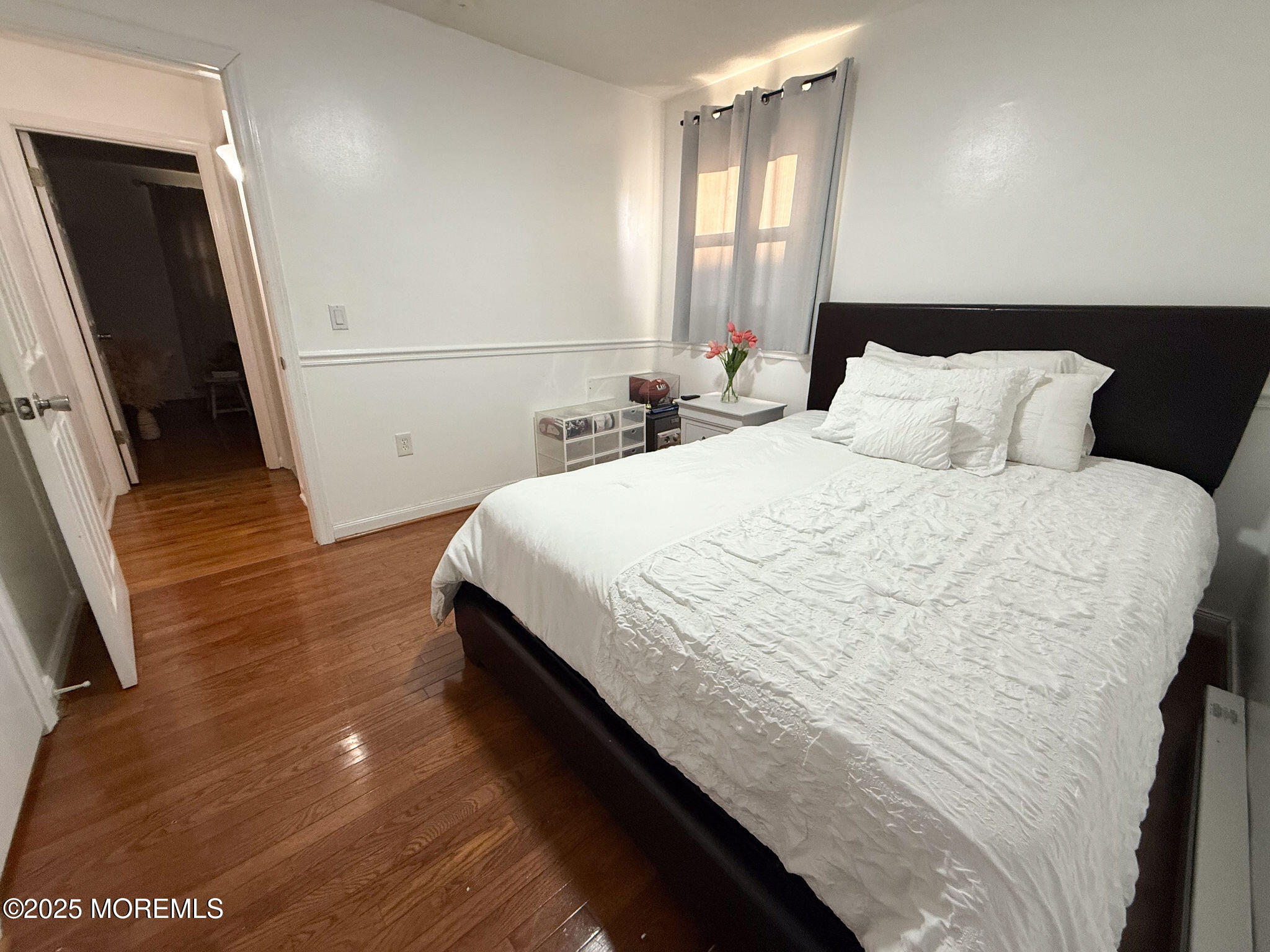 73 Maple Avenue, Unit 2 Keansburg, NJ 07734 - Photo 15 of 33 a bedroom with a bed and a flat tv screen on dresser