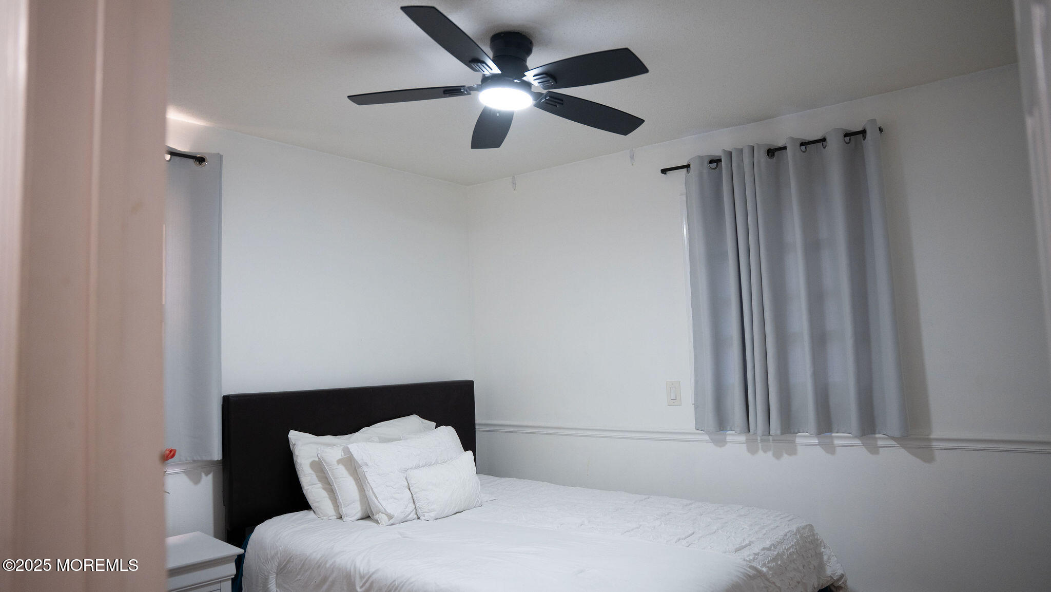 73 Maple Avenue, Unit 2 Keansburg, NJ 07734 - Photo 17 of 33 a bedroom with a bed and a ceiling fan