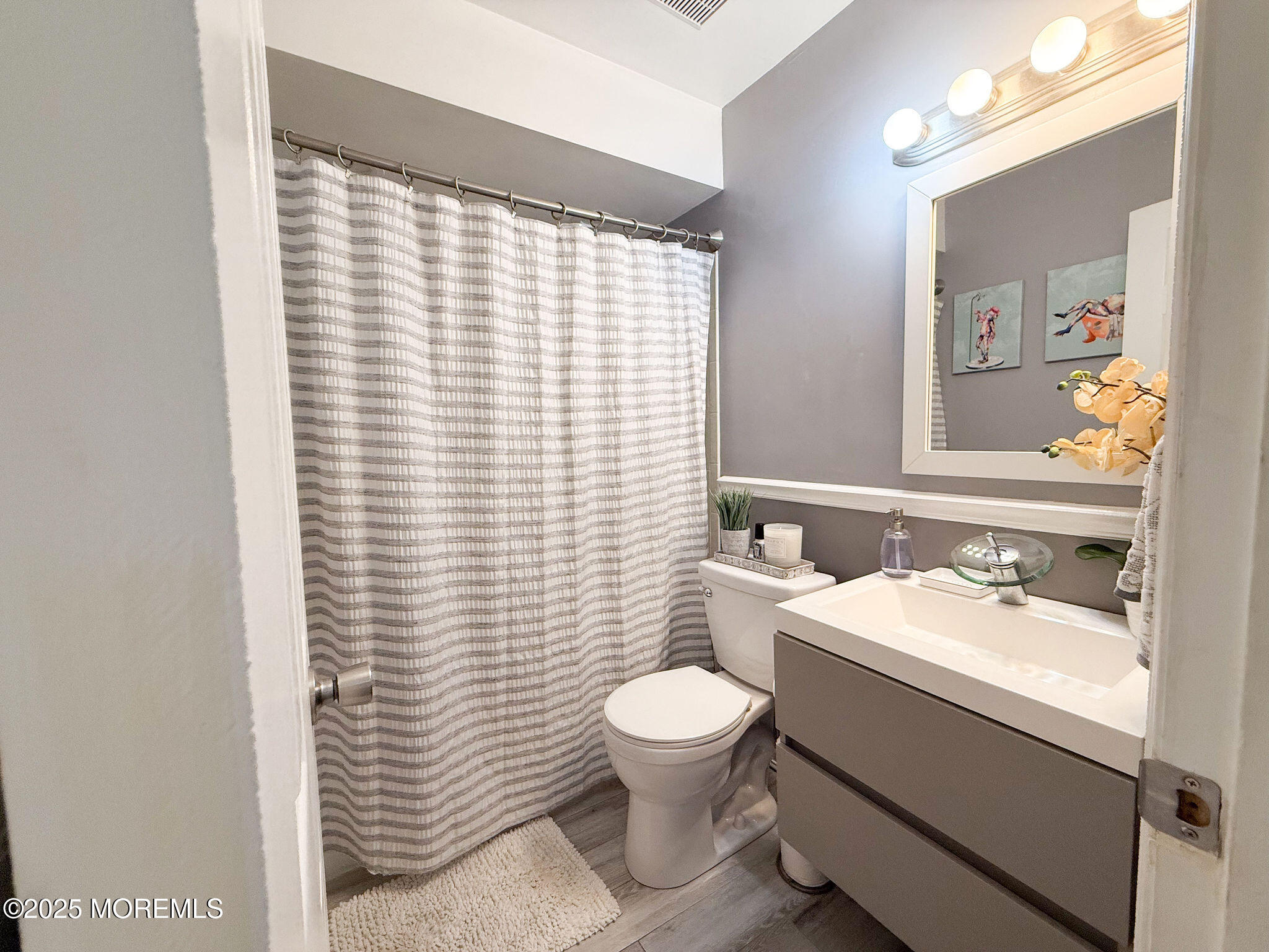 73 Maple Avenue, Unit 2 Keansburg, NJ 07734 - Photo 20 of 33 a bathroom with a sink a toilet and mirror