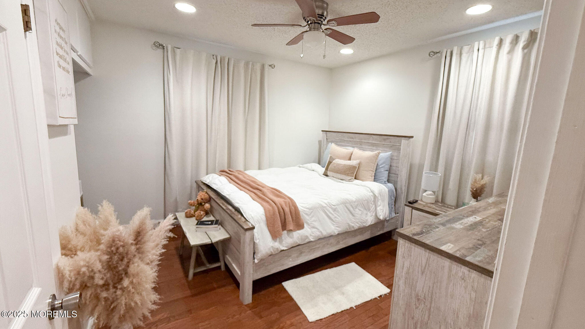 73 Maple Avenue, Unit 2 Keansburg, NJ 07734 - Photo 21 of 33 a bedroom with a bed and a chandelier