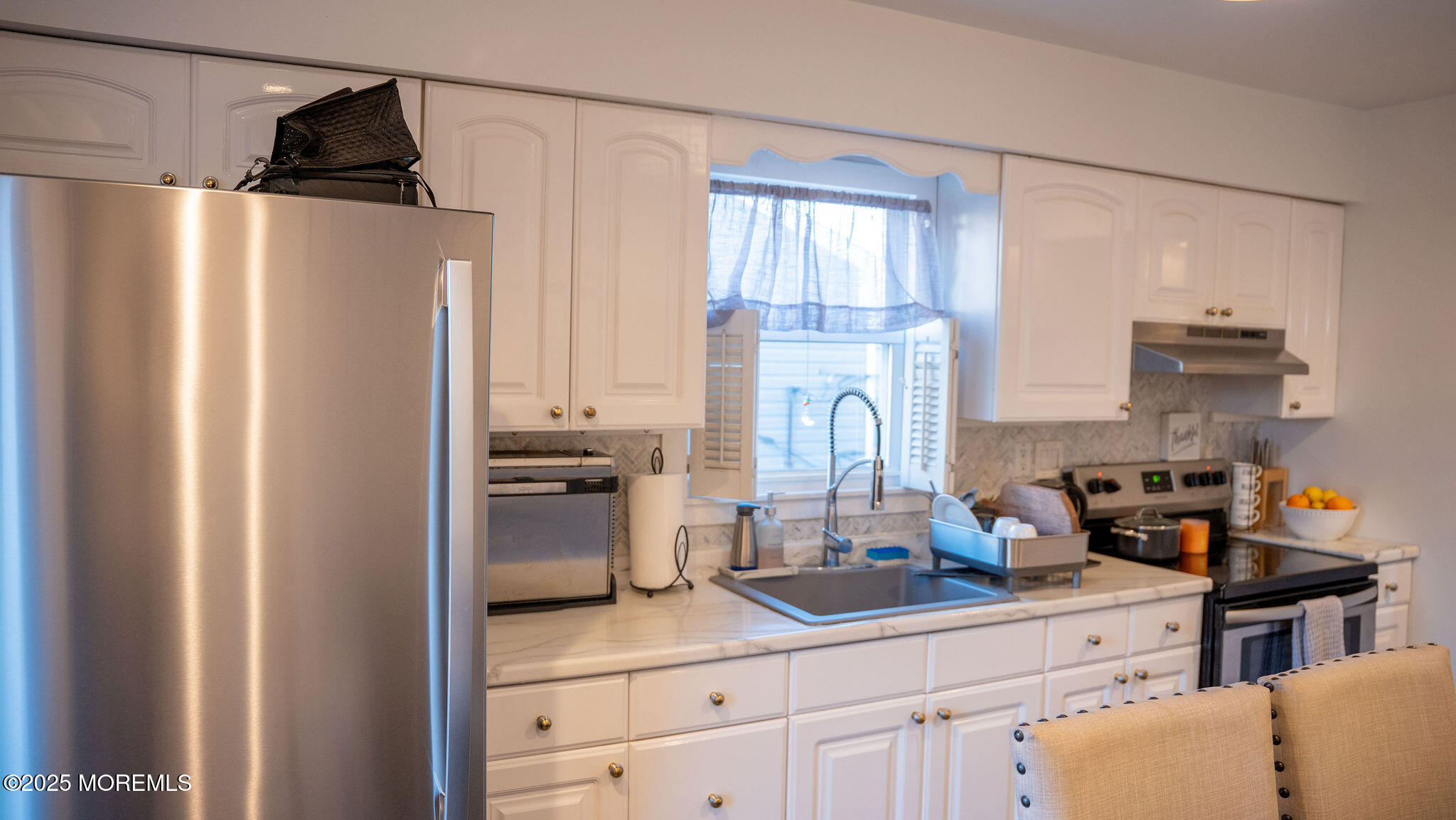 73 Maple Avenue, Unit 2 Keansburg, NJ 07734 - Photo 26 of 33 a kitchen with a refrigerator and cabinets