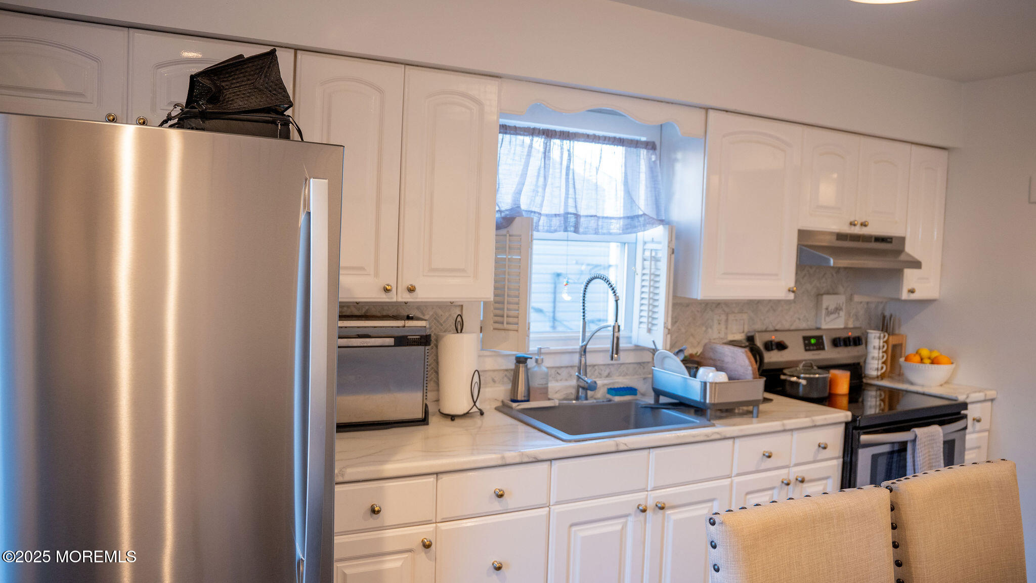 73 Maple Avenue, Unit 2 Keansburg, NJ 07734 - Photo 27 of 33 a kitchen with a refrigerator and a stove top oven