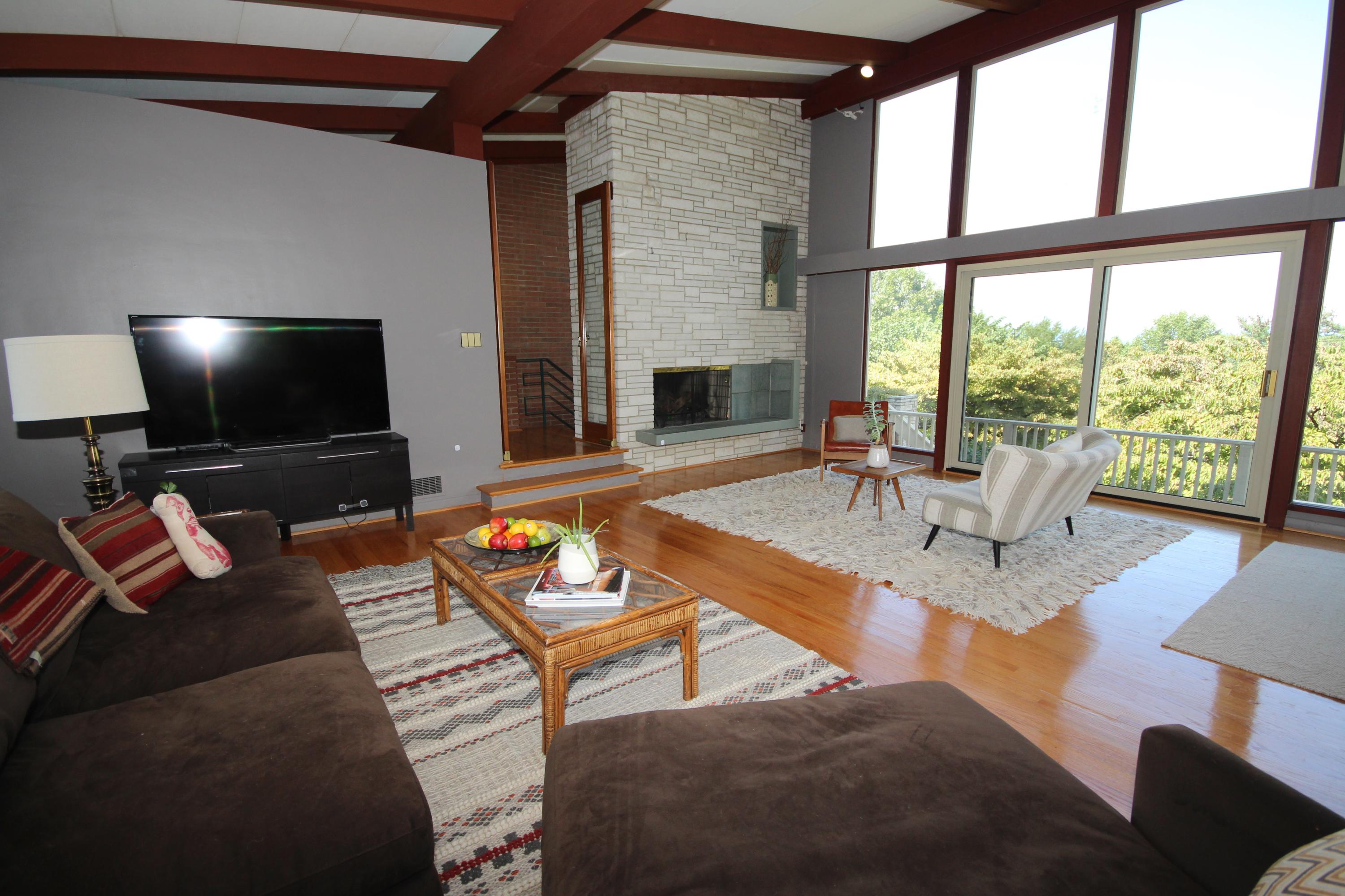 4507 Rosecrest Road Roanoke, VA 24018 - Photo 8 of 41 a living room with furniture a fireplace and a flat screen tv