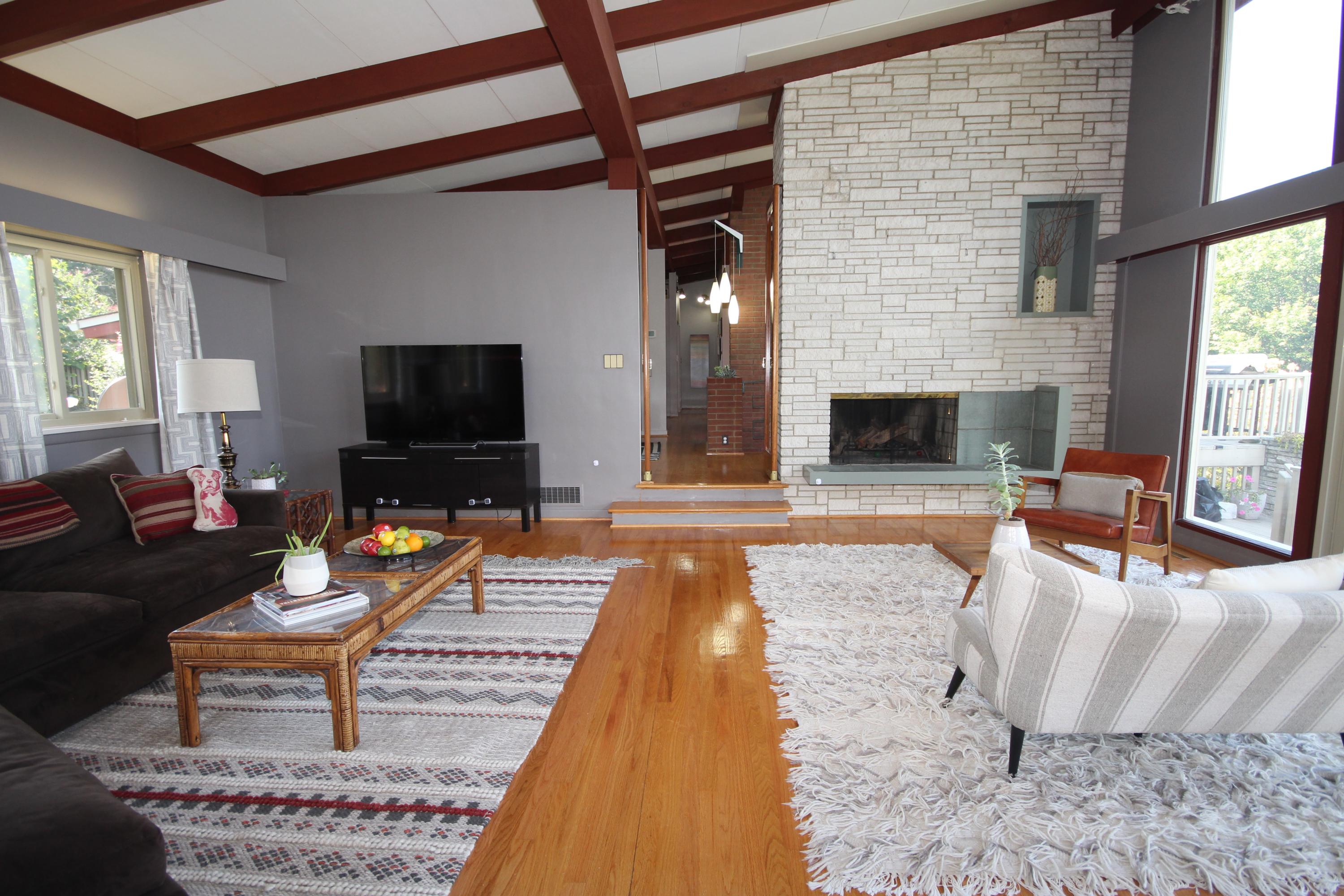 4507 Rosecrest Road Roanoke, VA 24018 - Photo 9 of 41 a living room with furniture a fireplace and a flat screen tv