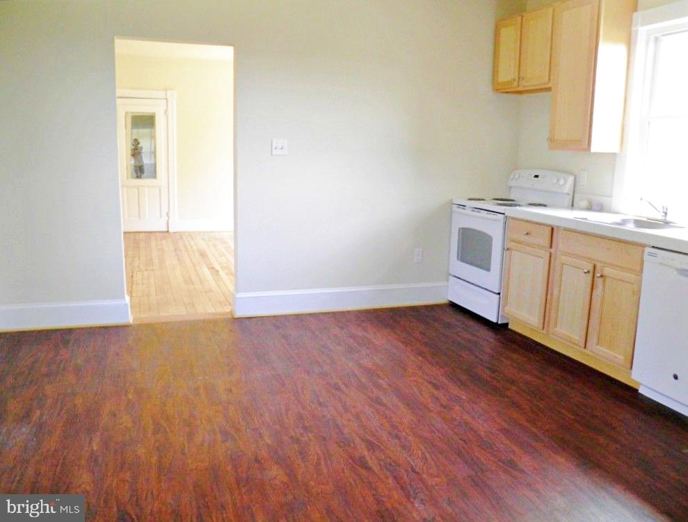 102 East A Street Brunswick, MD 21716 - Photo 11 of 18 a view of a kitchen with wooden floor and electronic appliances