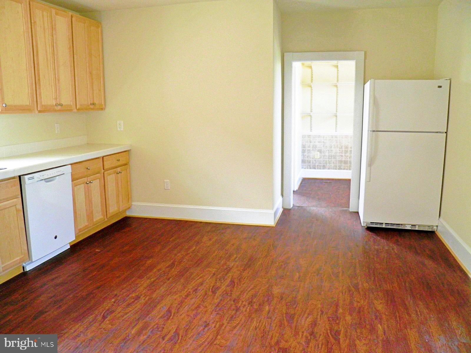 102 East A Street Brunswick, MD 21716 - Photo 12 of 18 a view of a kitchen with wooden floor and electronic appliances