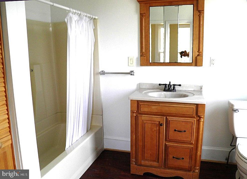 102 East A Street Brunswick, MD 21716 - Photo 13 of 18 a bathroom with a sink a mirror and a window
