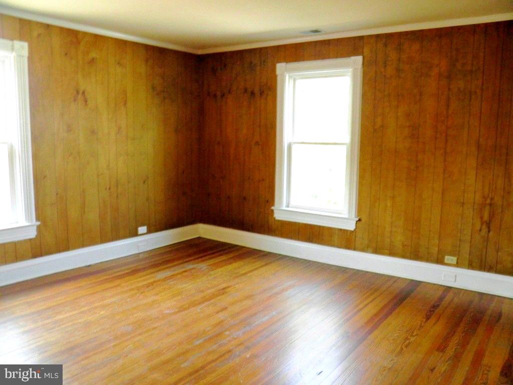 102 East A Street Brunswick, MD 21716 - Photo 15 of 18 a view of an empty room with wooden floor and a window