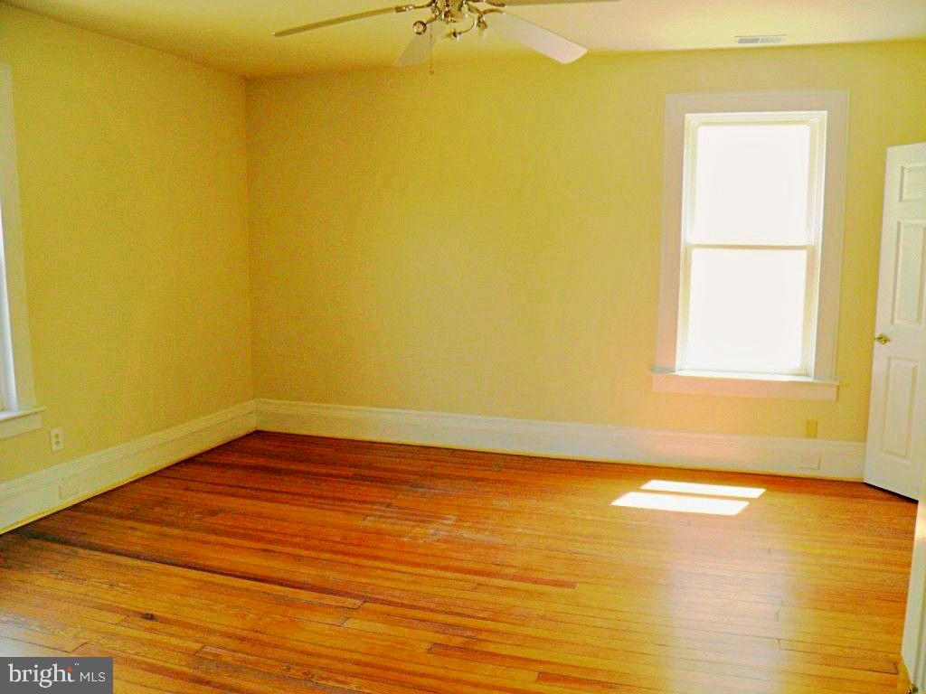 102 East A Street Brunswick, MD 21716 - Photo 16 of 18 a view of a room with wooden floor and a window