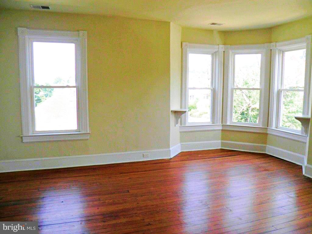 102 East A Street Brunswick, MD 21716 - Photo 3 of 18 a view of empty room with wooden floor and fan