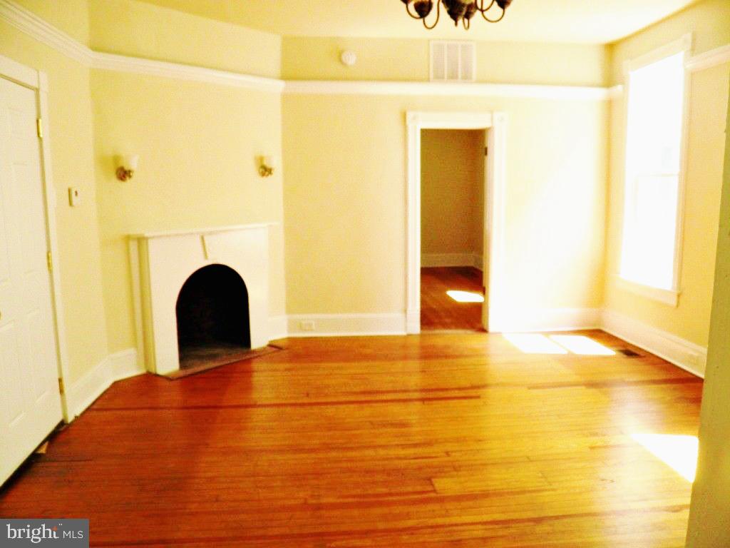 102 East A Street Brunswick, MD 21716 - Photo 4 of 18 a view of an empty room with wooden floor