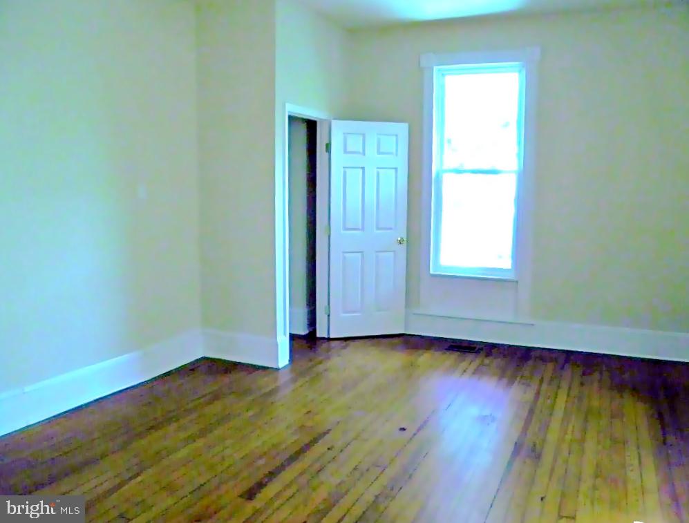 102 East A Street Brunswick, MD 21716 - Photo 7 of 18 an empty room with wooden floor and windows