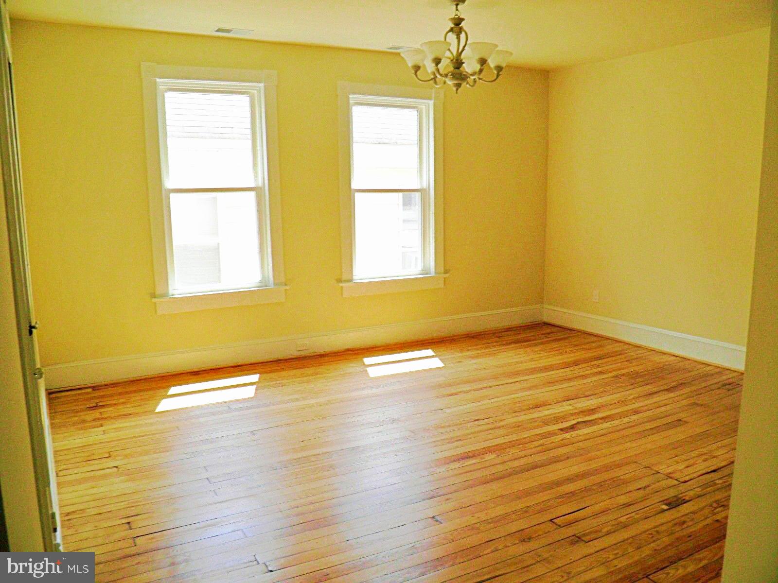 102 East A Street Brunswick, MD 21716 - Photo 9 of 18 a view of empty room with wooden floor and fan