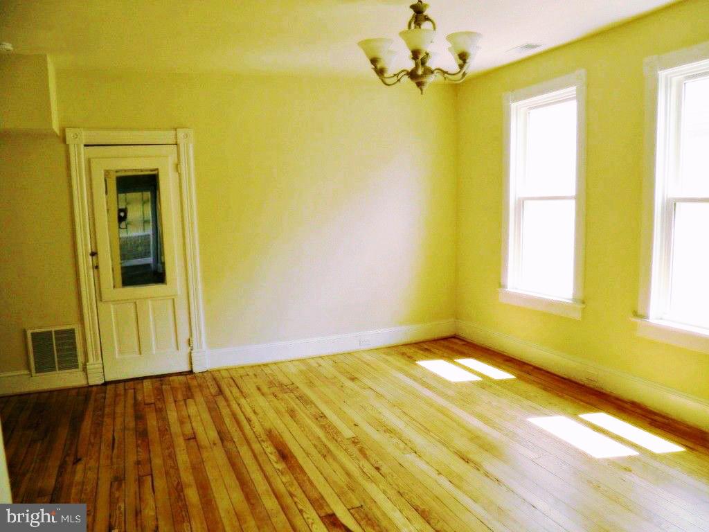 102 East A Street Brunswick, MD 21716 - Photo 10 of 18 a view of a room with a wooden floor and a window