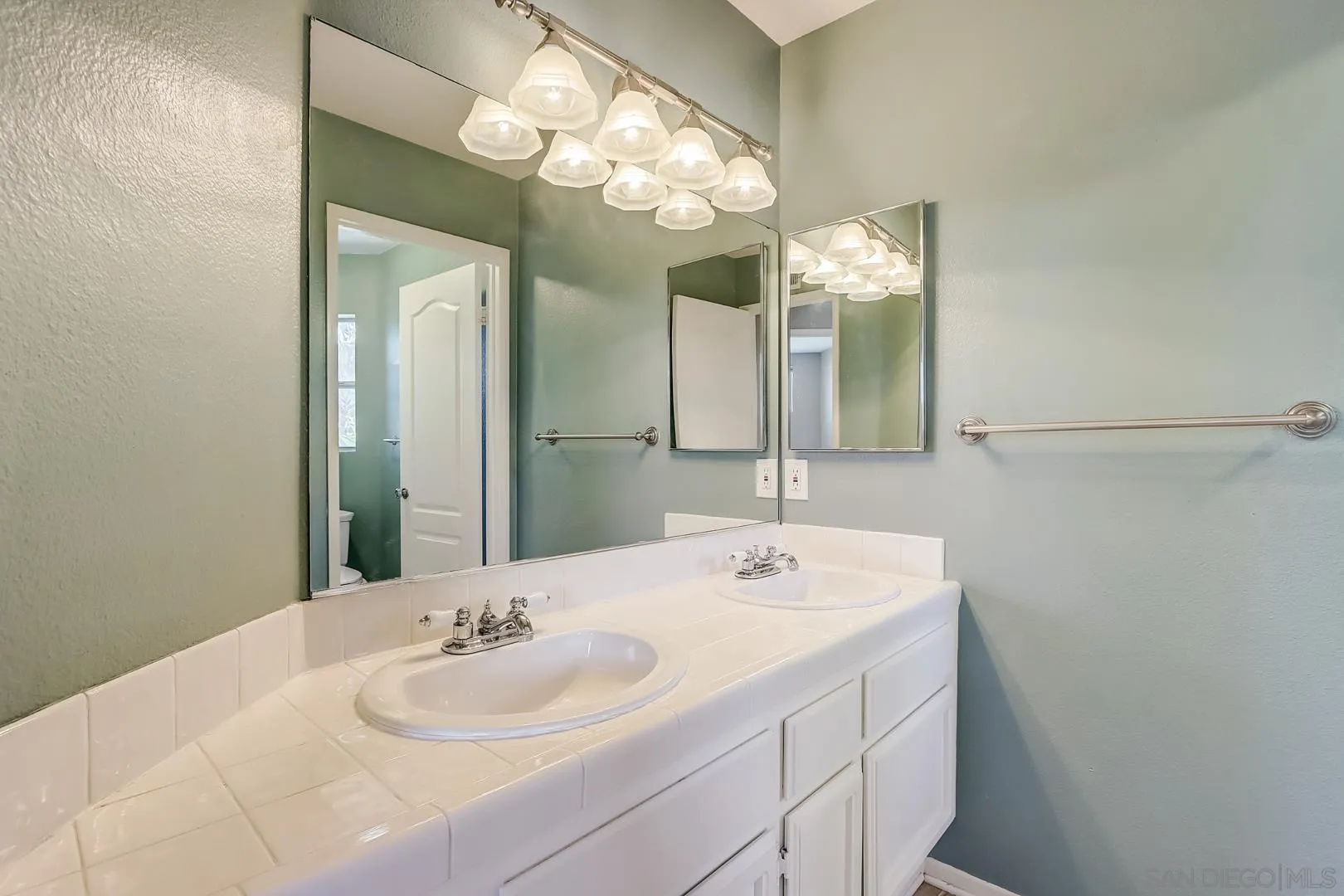4824 Contour Court Oceanside, CA 92057 - Photo 15 of 32 a bathroom with a sink and a mirror
