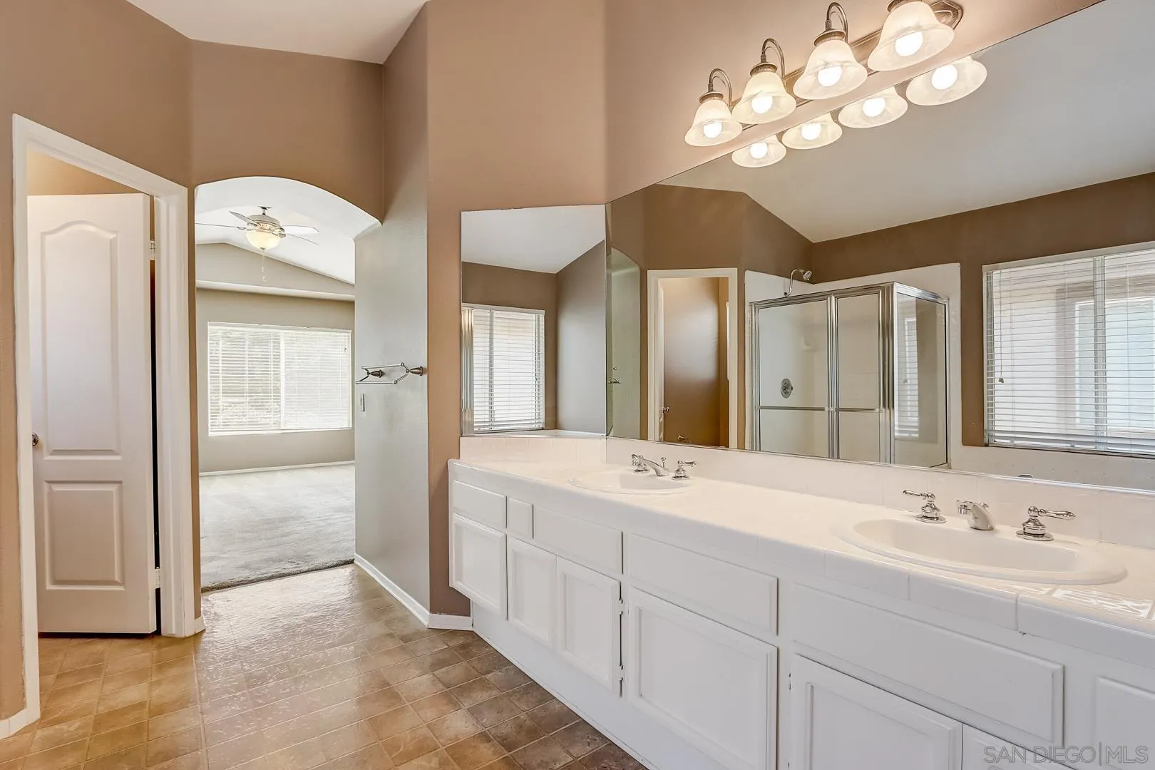 4824 Contour Court Oceanside, CA 92057 - Photo 18 of 32 a spacious bathroom with a double vanity sink a large mirror and a shower