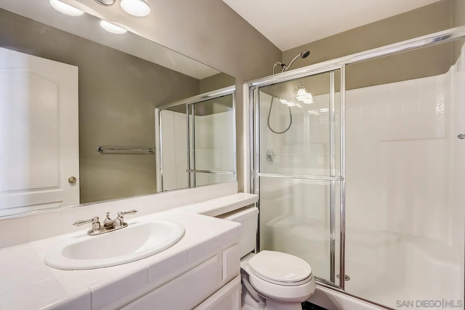 4824 Contour Court Oceanside, CA 92057 - Photo 21 of 32 a bathroom with a sink a toilet and shower
