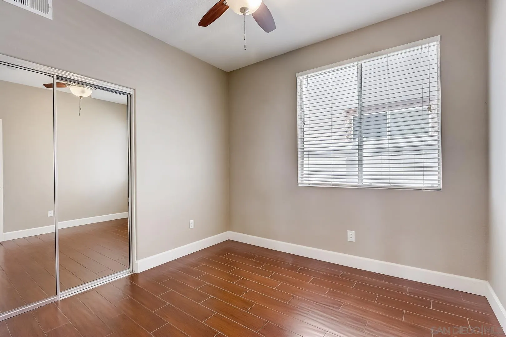 4824 Contour Court Oceanside, CA 92057 - Photo 22 of 32 a view of an empty room with a window and wooden floor